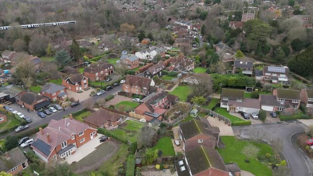 Aerial view of a quaint neighborhood with scattered houses, tree-lined roads, and integrated green spaces, highlighting relaxed suburban living