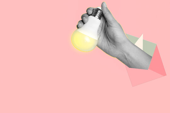 A Hand hold light bulb isolated on painted pink background. Creativity and new ideas in business. Art collage.