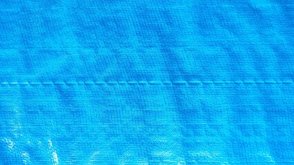 blue plastic canvas texture background. Creased plastic blue polyethylene film texture