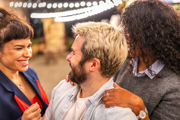 Distracted friends taking selfies during night party outdoors