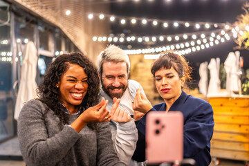 Friends streaming online and gesturing love during night party