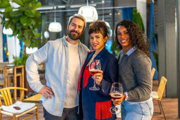 Portrait of happy friends holding beer at night party outdoors