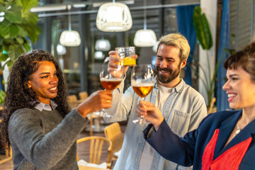Multi-ethnic friends raising glasses and celebrating success at night party