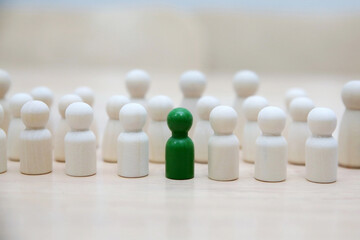 green leader businessman with crowd of wooden men. leadership, business, team, teamwork and Human resource management concept 