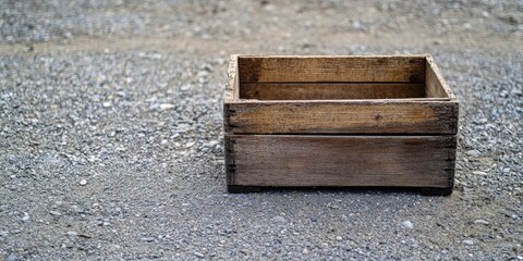 Wooden carrying box placed on the ground, showcasing the rugged texture and design of the wooden carrying box for potential use in storage and transport solutions.