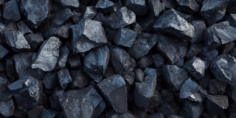 Large pieces of black coal arranged in a pile create a striking background. The texture of the black coal adds depth and character to the visual, making it an impactful image of black coal.