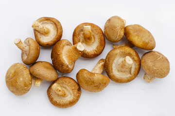 Fresh shiitake mushrooms on white background.