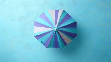 Obraz premium Striped Beach Umbrella on Blue Background: Summer Vibes