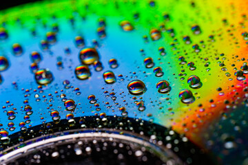 Abstract macro photo of extremely colorful water drops on dvd surface