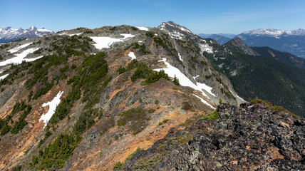Scenic landscape of rocky mountain ridge top and snow capped peaks