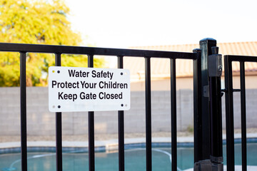 Pool safety gate with sign emphasizing water safety