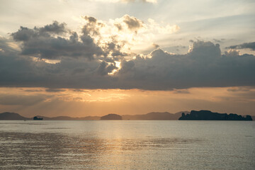 Tropical sunset seascape with islands and golden sky, Thailand