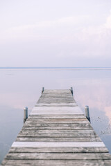 Obraz premium A peaceful sunset on a dock of Oneida Lake in summer.