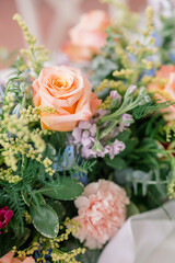 Close-up of elegant floral centerpiece with peach roses.