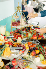 Guest serving from an elaborate, vibrant charcuterie table.
