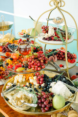 Luxurious charcuterie display with fruits, cheeses, and garnishes.