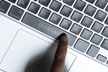 Close-up of a hand pressing a keyboard key labeled 