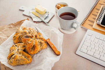 Lunch in a office, delicious bread rolls with butter and coffee on desktopffee