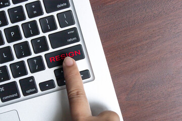 Close-up of a hand pressing a keyboard key with the word 