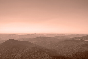 silhouettes of mountain peaks, landscape in the color of the year 2025 Mocha Mousse. High quality...
