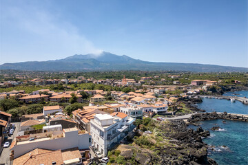 View from above of the coast and the Etna volcano in the background in the Acireale area in Sicily