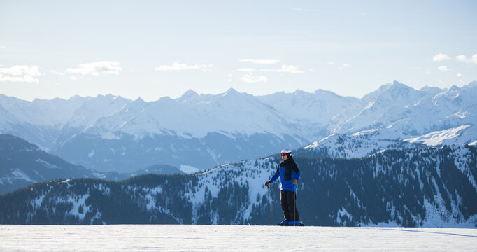 Skier on snowy slopes with majestic Kitzb&uuml;hel alpine backdrop
