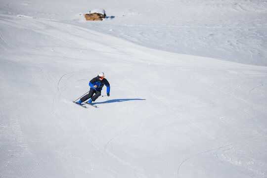 Skiing enthusiast carving turns on a pristine slope in Kitzb&uuml;hel