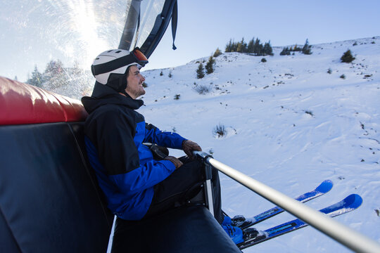 Man enjoying a scenic chairlift ride in Kitzb&uuml;hel Alps