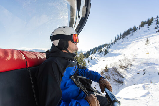 Man enjoying a scenic chairlift ride in Kitzb&uuml;hel Alps