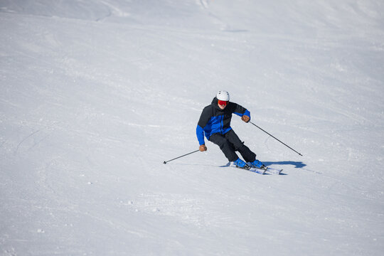 Skiing enthusiast carving turns on a pristine slope in Kitzb&uuml;hel