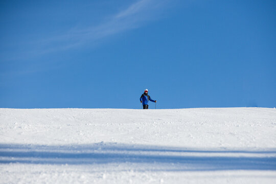 Skier on snowy slope with clear blue sky in Kitzb&uuml;hel, Austria