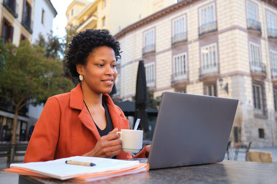 Businesswoman working remotely enjoying a coffee in Madrid, Spain