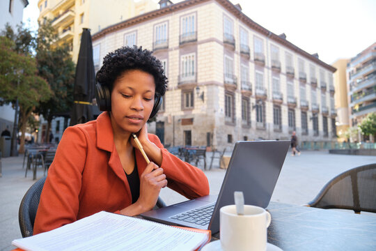 Focused businesswoman working remotely in a european city square