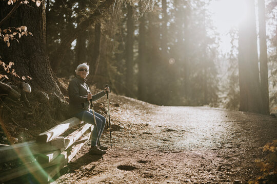 Elderly woman takes a break while hiking in Yosemite, California