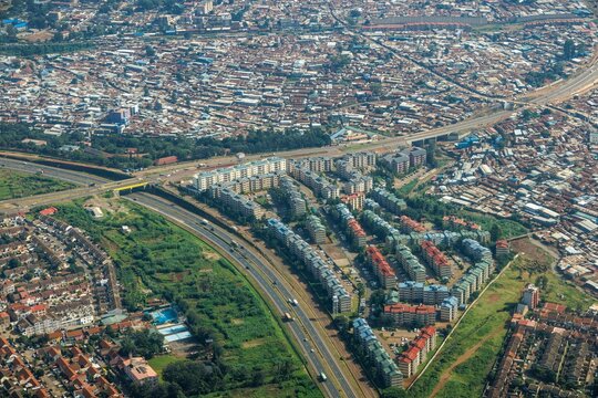 Modern housing (bottom) near the Kibera slum (top) in Nairobi.