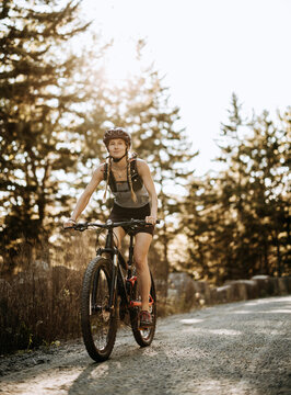 Female mountain biker rides along carriage trail, Bar Harbor, Maine