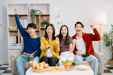 Young Asian friend having, enjoy evening party together at home. Attractive young man and woman having fun, eating foo