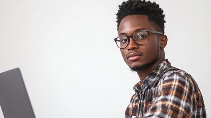 Fototapeta premium Young african male developer working on laptop empowering black business professionals