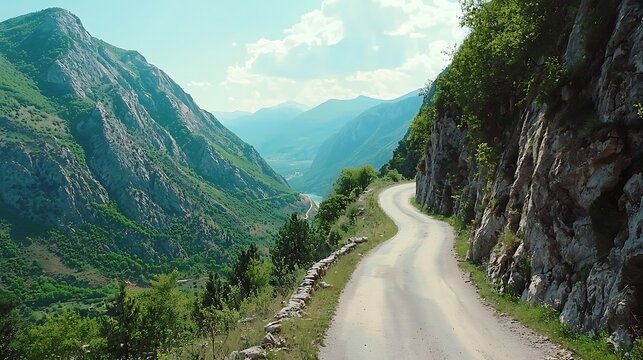 A winding road with a mountain range in the background