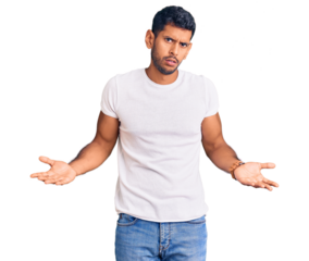 Young latin man wearing casual clothes clueless and confused with open arms, no idea concept.