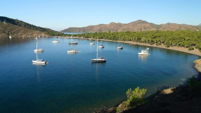 Beautiful Aktur beach. Sailboats and beautiful nature in a wonderful sea climate. Background for your holiday. Datca Peninsula, Aegean Region. Mugla city, Turkey country  - 4k video 