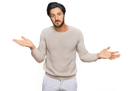 Young hispanic man wearing casual clothes clueless and confused expression with arms and hands raised. doubt concept.
