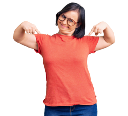 Brunette woman with down syndrome wearing casual clothes and glasses looking confident with smile on face, pointing oneself with fingers proud and happy.