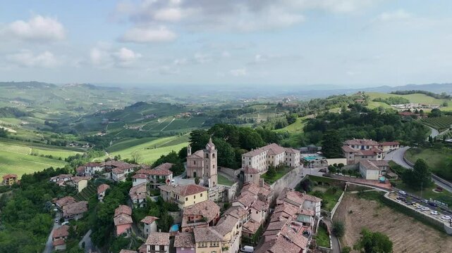 Monforte d'Alba, Langhe region, Cuneo, Piedmont, Italy. 4k aerial view of the church square and the Horszowski auditorium. Langhe-Roero and Monferrato. Circling forward to the left.