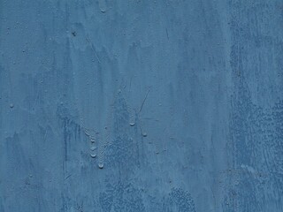 Mysterious blue fingers coming out of blue painted metal surface