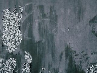 Severely peeled paint on a metal surface, with scratches, grafitti and dirt