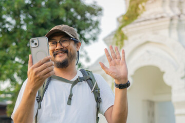Happy tourist take selfie self-portrait with smartphone in the famous temple