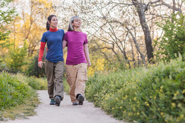 Fototapeta premium Lesbian couple walking in countryside, enjoying nature and fresh air