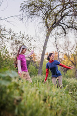 Two happy friends enjoying nature, walking in the countryside