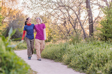 Two friends walking and laughing in nature